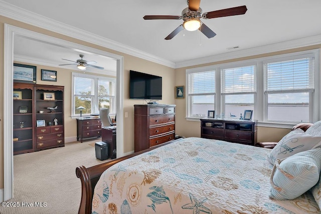 carpeted bedroom featuring baseboards, multiple windows, crown molding, and visible vents