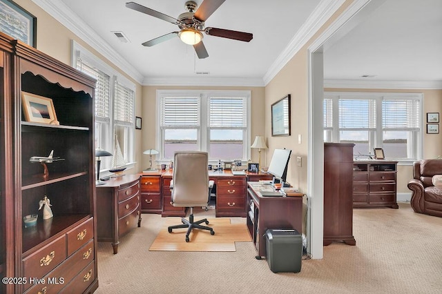 office space featuring light colored carpet, visible vents, a ceiling fan, and a healthy amount of sunlight