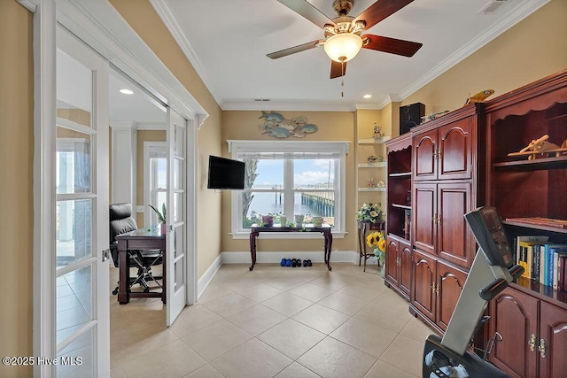 office space with a ceiling fan, baseboards, visible vents, light tile patterned flooring, and crown molding