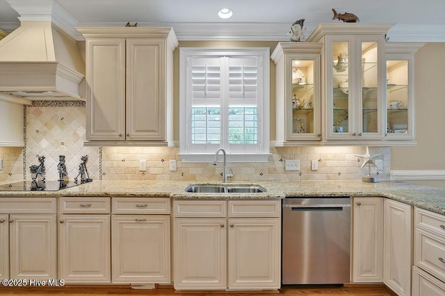 kitchen with dishwasher, premium range hood, light stone counters, and a sink