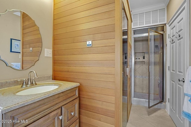 bathroom with an enclosed shower, tile patterned flooring, vanity, and crown molding