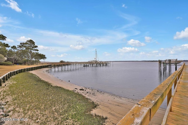 dock area featuring a beach view and a water view
