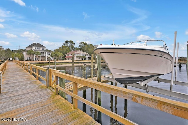 view of dock featuring a water view and boat lift