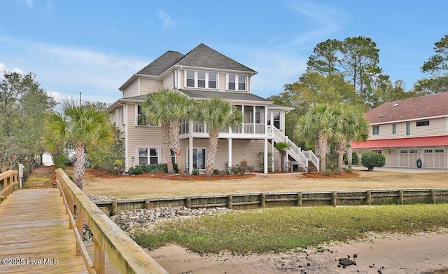 rear view of property featuring stairs