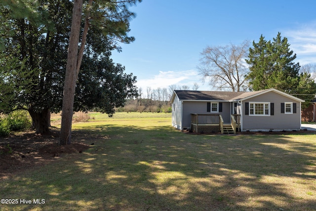 exterior space featuring crawl space, a yard, and a deck