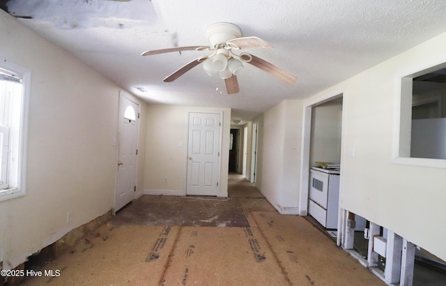 interior space with a textured ceiling and ceiling fan