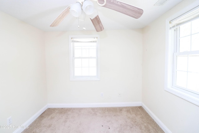 unfurnished room featuring visible vents, a ceiling fan, baseboards, and light carpet