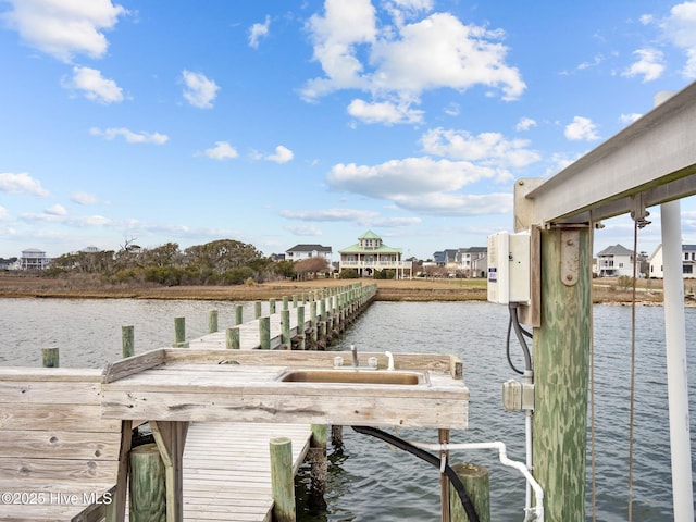 view of dock featuring a sink and a water view