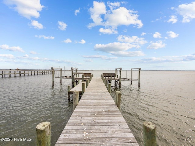 view of dock with boat lift and a water view