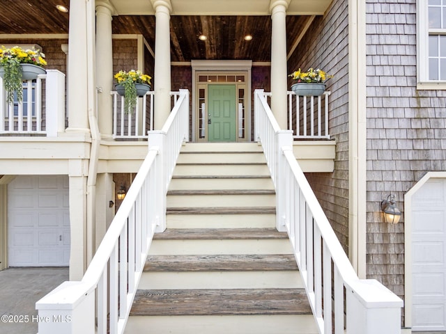 doorway to property with a porch and an attached garage