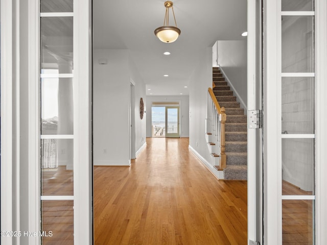 entrance foyer with stairway, recessed lighting, baseboards, and light wood finished floors