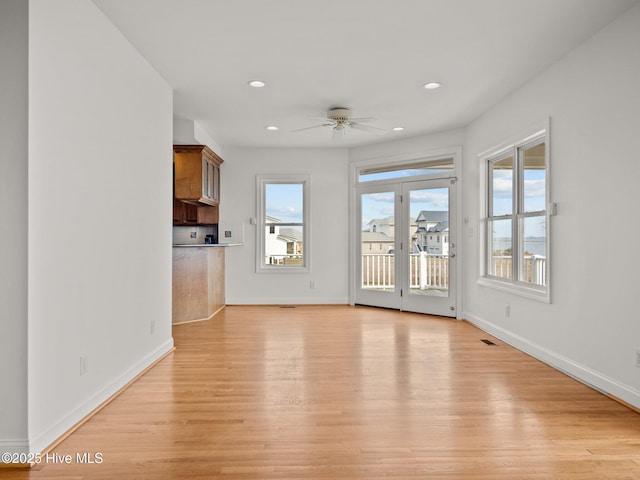 unfurnished living room with recessed lighting, light wood-style flooring, baseboards, and ceiling fan