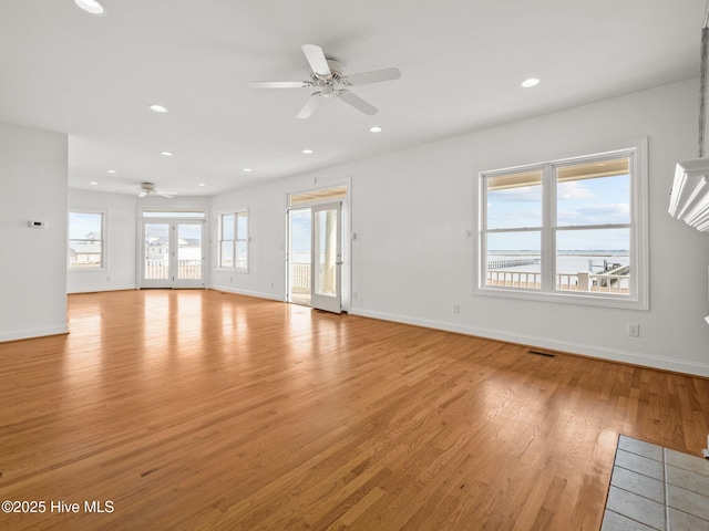 unfurnished living room featuring recessed lighting, light wood-type flooring, baseboards, and ceiling fan