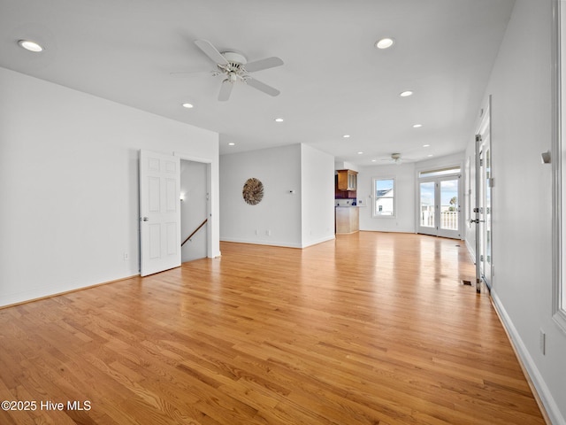 unfurnished living room with recessed lighting, a ceiling fan, light wood-style floors, and baseboards