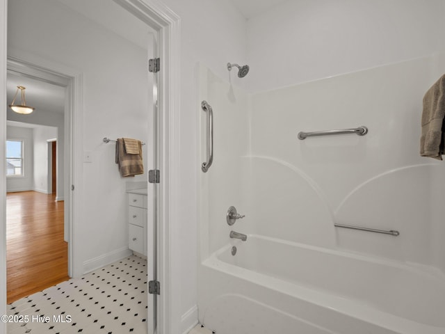 full bathroom featuring tile patterned floors, baseboards, and shower / tub combination