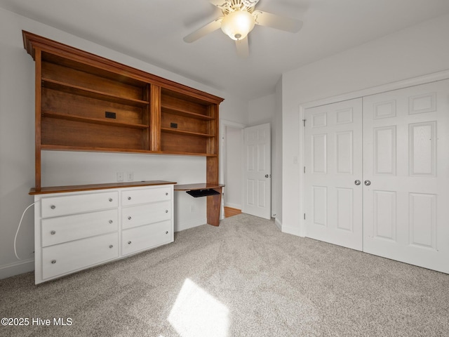 unfurnished bedroom featuring a closet, ceiling fan, baseboards, and carpet