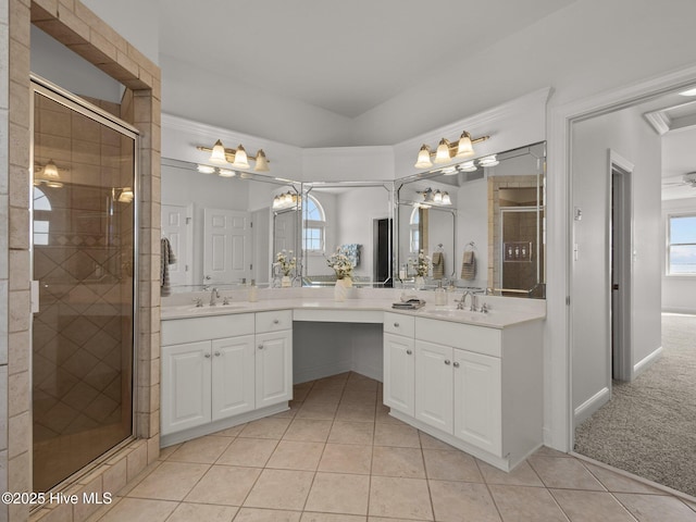 bathroom featuring a healthy amount of sunlight, a stall shower, vanity, and tile patterned flooring