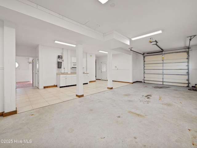 garage featuring baseboards and a garage door opener