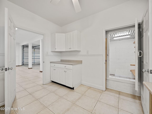 kitchen with light tile patterned floors, white cabinetry, light countertops, and ceiling fan