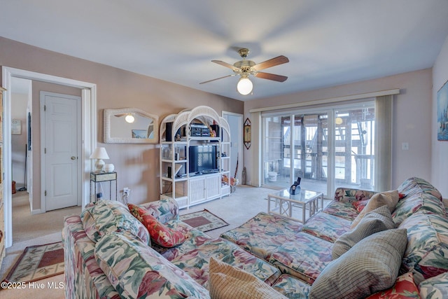 carpeted living area with ceiling fan