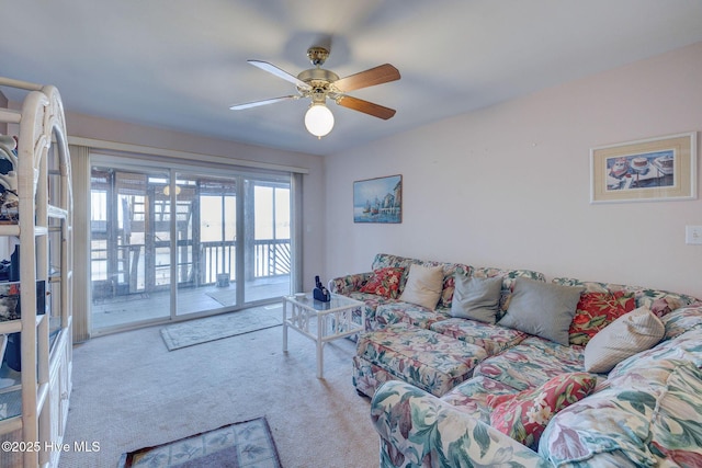 carpeted living room featuring a ceiling fan