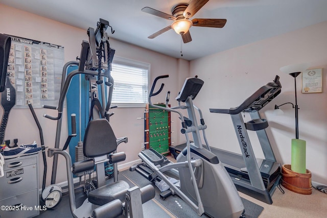 workout room featuring baseboards and a ceiling fan