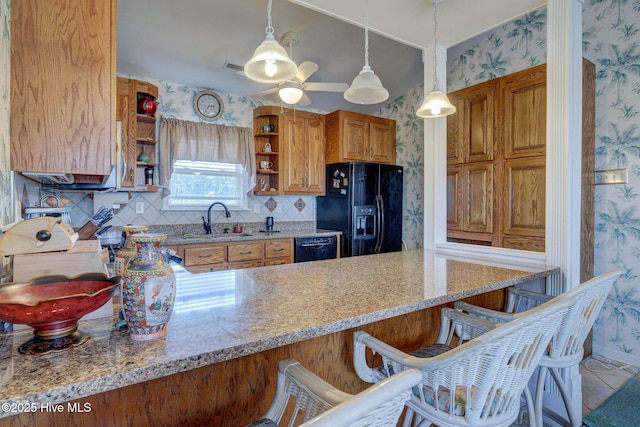 kitchen with open shelves, black appliances, a sink, and wallpapered walls