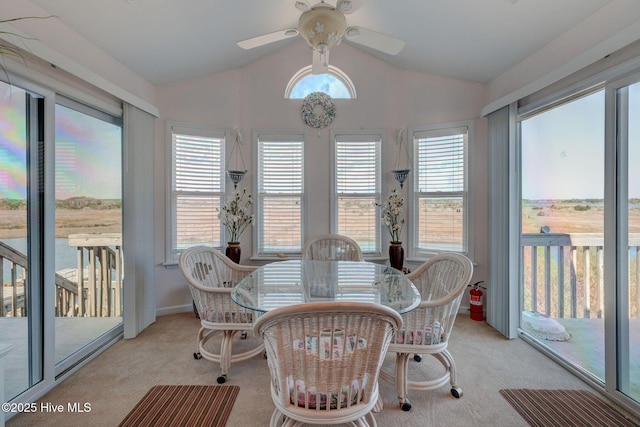 sunroom / solarium featuring lofted ceiling and a ceiling fan