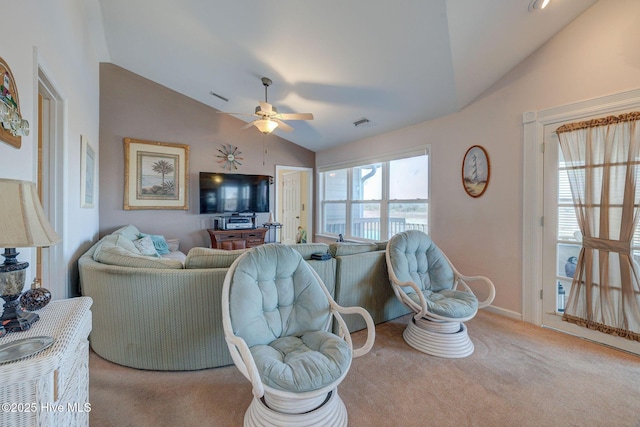 carpeted living room featuring vaulted ceiling, a ceiling fan, and visible vents