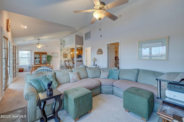 carpeted living area featuring visible vents, high vaulted ceiling, a ceiling fan, and french doors