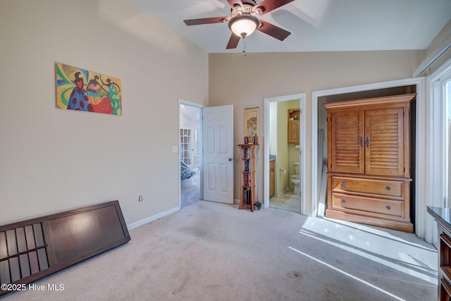 unfurnished bedroom featuring baseboards, ensuite bathroom, carpet, and vaulted ceiling