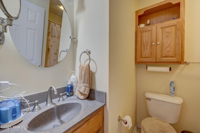 full bathroom with toilet and vanity