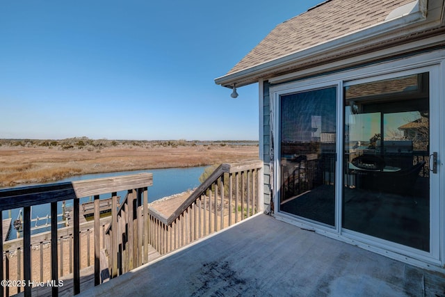 wooden terrace featuring a water view