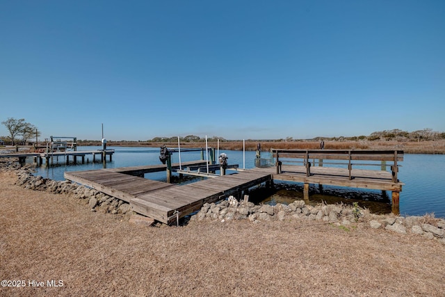 view of dock featuring boat lift and a water view