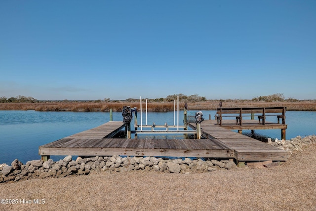 dock area with a water view and boat lift