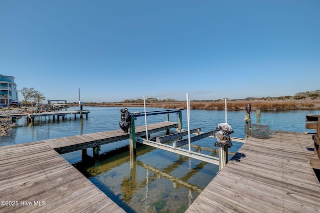 view of dock featuring a water view and boat lift