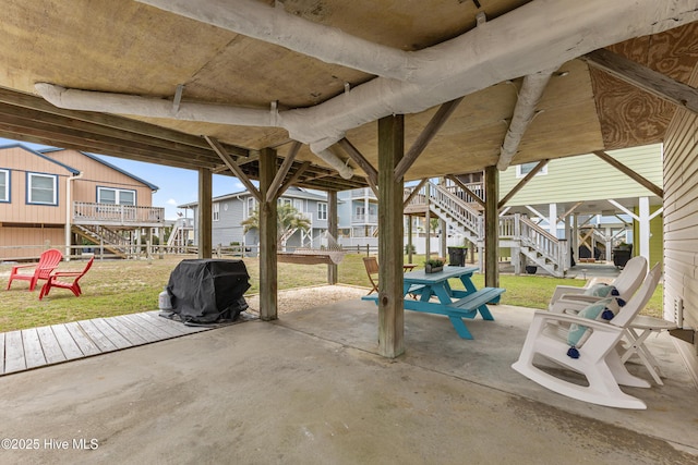 view of patio / terrace with a wooden deck, area for grilling, and stairs