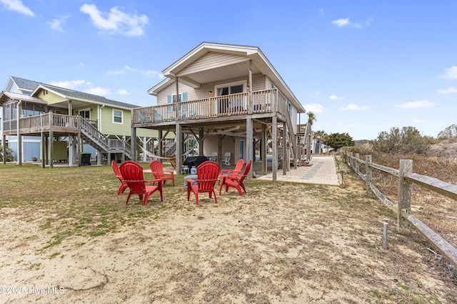 rear view of property featuring a deck and stairway