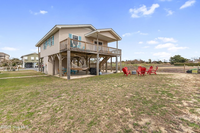 rear view of property featuring a patio, stairway, a wooden deck, a carport, and a lawn