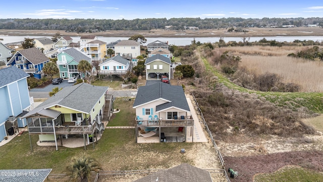 birds eye view of property featuring a residential view and a water view