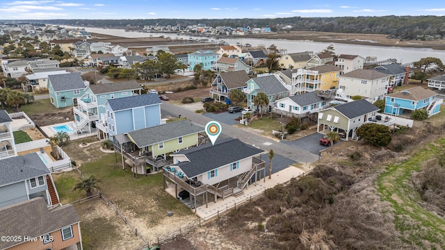 birds eye view of property featuring a residential view and a water view