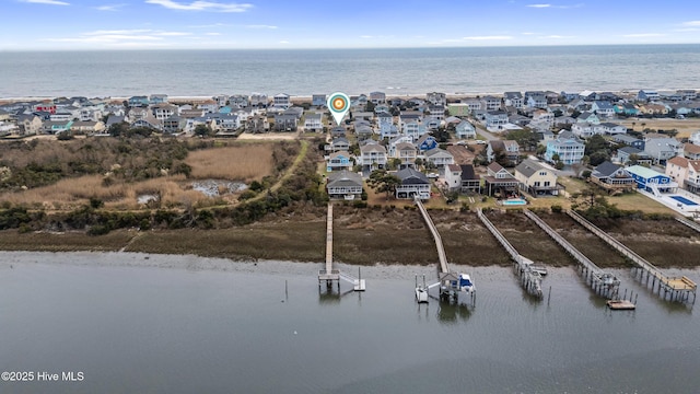 birds eye view of property featuring a water view and a residential view