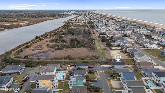 drone / aerial view featuring a beach view and a water view