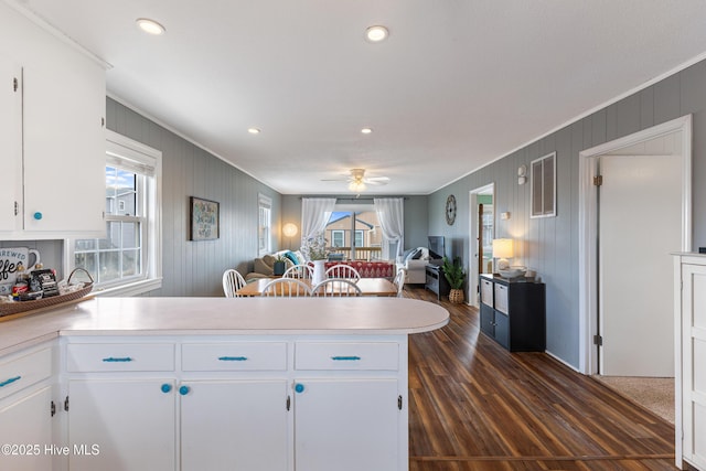 kitchen featuring ceiling fan, a peninsula, open floor plan, and light countertops