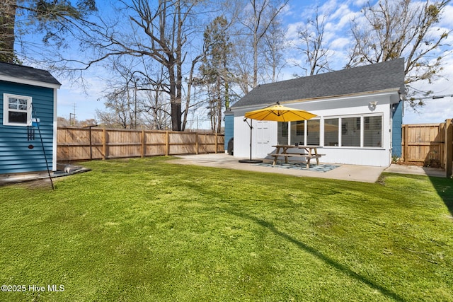 back of property with an outdoor structure, a fenced backyard, a patio area, and a lawn