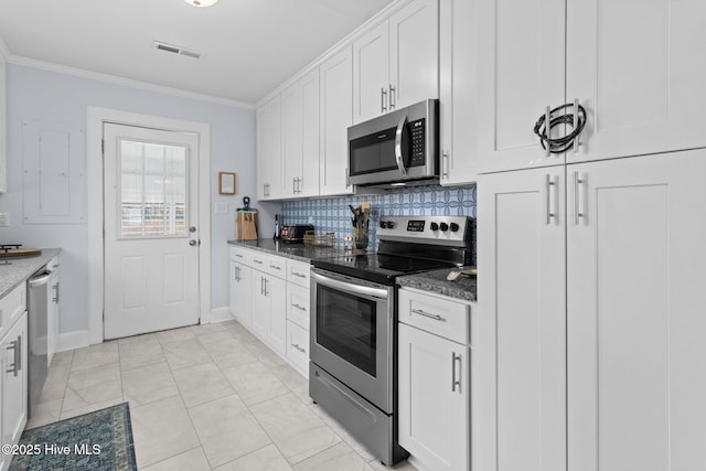 kitchen with tasteful backsplash, stainless steel appliances, visible vents, white cabinets, and ornamental molding