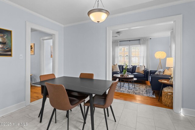 dining area with baseboards and ornamental molding