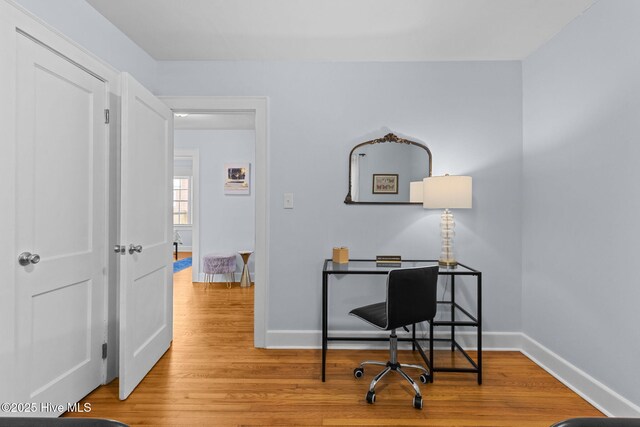office space with baseboards and wood finished floors