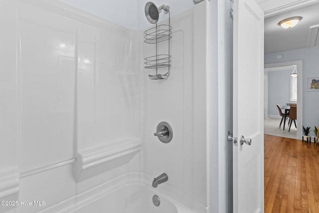 bathroom with shower / bathing tub combination and wood finished floors