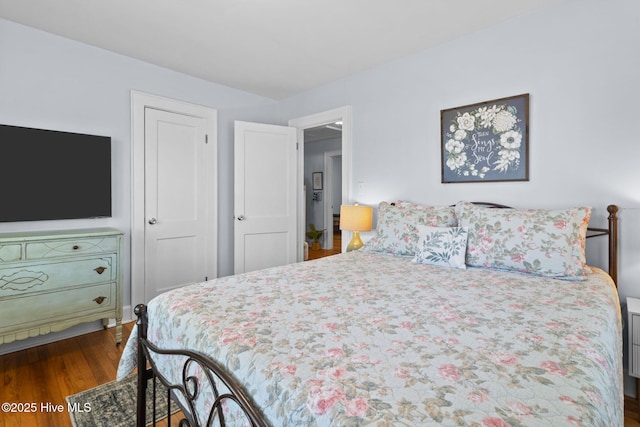 bedroom with dark wood-type flooring